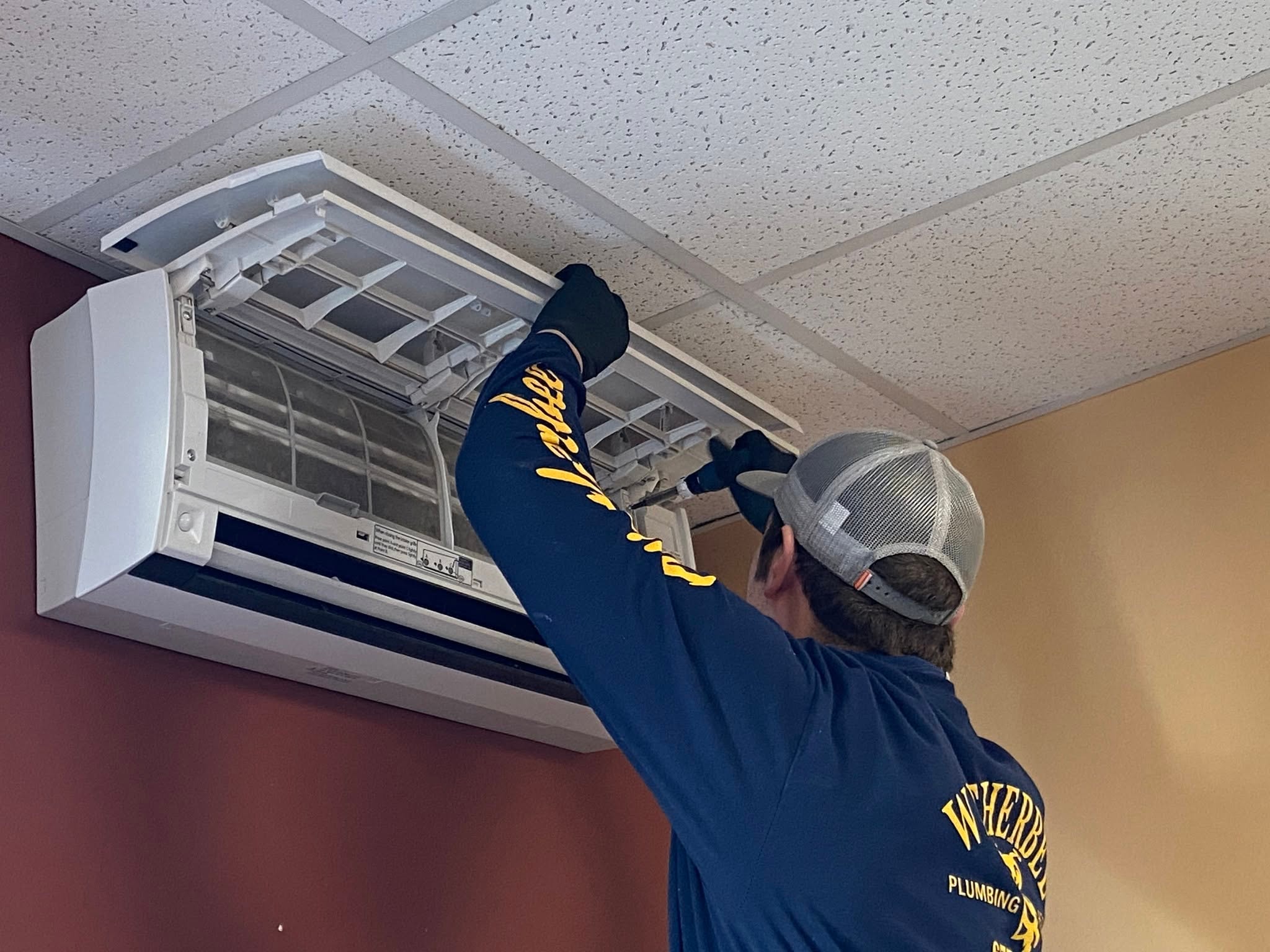 Wetherbee technician servicing a mini-split air handler