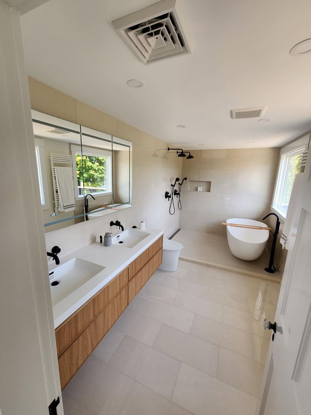Modern bathroom renovation with freestanding tub and double vanity